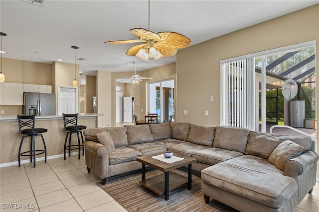 living room with ceiling fan and light tile patterned floors