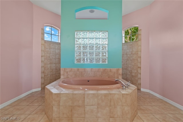 2249 Valencia Lakes Cir, Naples, FL 34120 - bathroom with a garden tub, tile patterned flooring, and baseboards