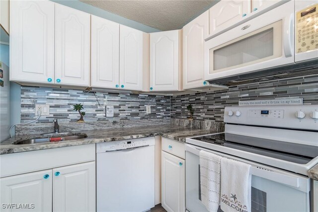 kitchen featuring backsplash, white appliances, and white cabinetry