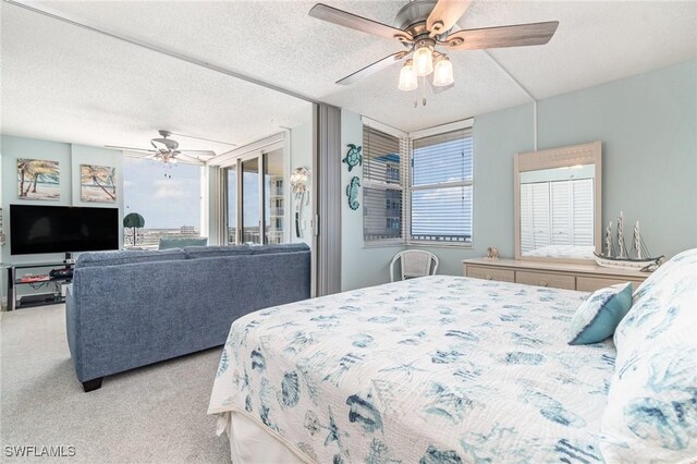 carpeted bedroom with a textured ceiling and ceiling fan