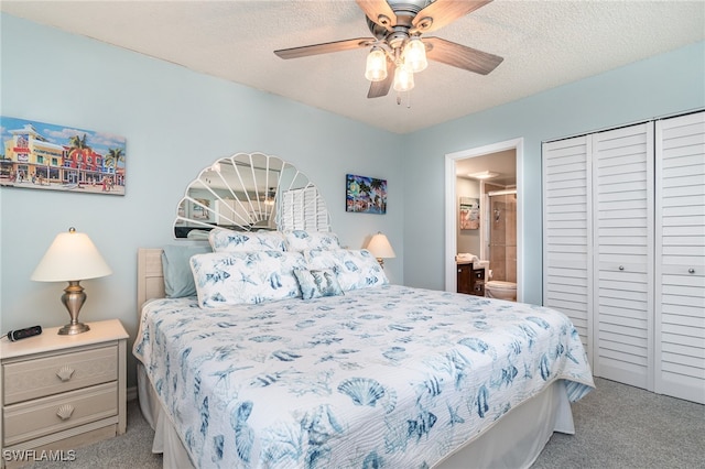 bedroom featuring ceiling fan, a textured ceiling, light carpet, and ensuite bathroom