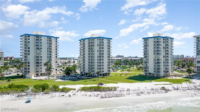 exterior space featuring a water view and a view of the beach