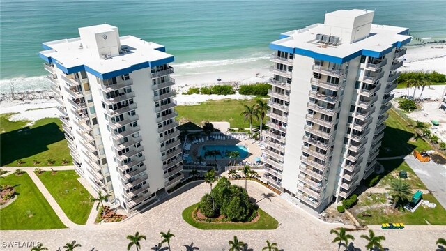 drone / aerial view featuring a water view and a beach view