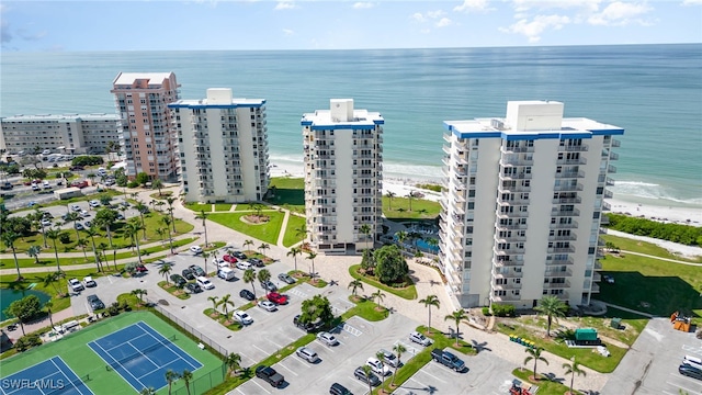 drone / aerial view featuring a water view and a beach view