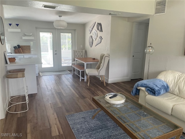 living room featuring dark hardwood / wood-style floors and french doors