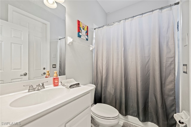 bathroom featuring vanity, toilet, and a shower with curtain