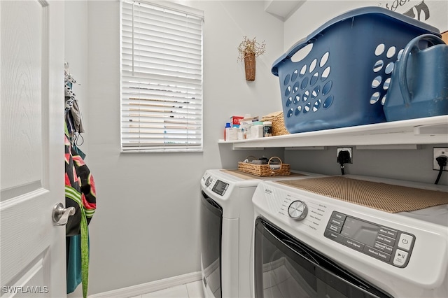 laundry room featuring washing machine and dryer and tile patterned floors