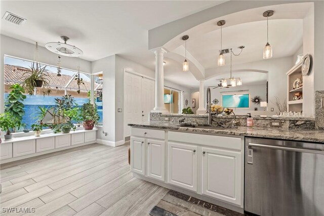 11490 Axis Deer Ln, Fort Myers, FL 33966 - kitchen featuring dishwasher, ornate columns, light wood-type flooring, white cabinetry, and light stone counters