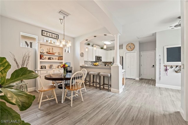 11490 Axis Deer Ln, Fort Myers, FL 33966 - dining area featuring ornate columns and light wood-style flooring