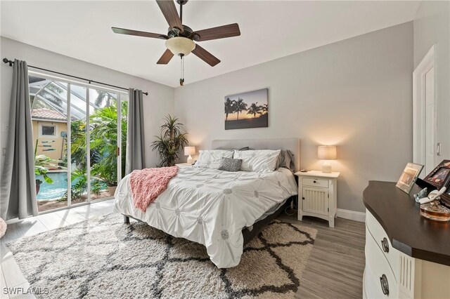 bedroom with light hardwood / wood-style floors, ceiling fan, and access to outside