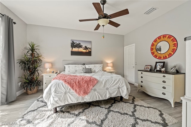 bedroom with light hardwood / wood-style flooring and ceiling fan