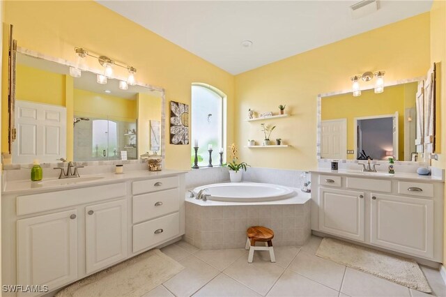 bathroom featuring tile patterned flooring, vanity, and independent shower and bath