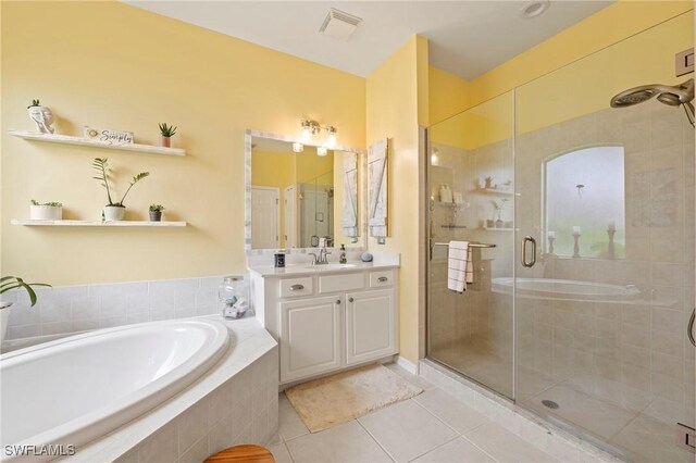 bathroom with vanity, tile patterned floors, and shower with separate bathtub