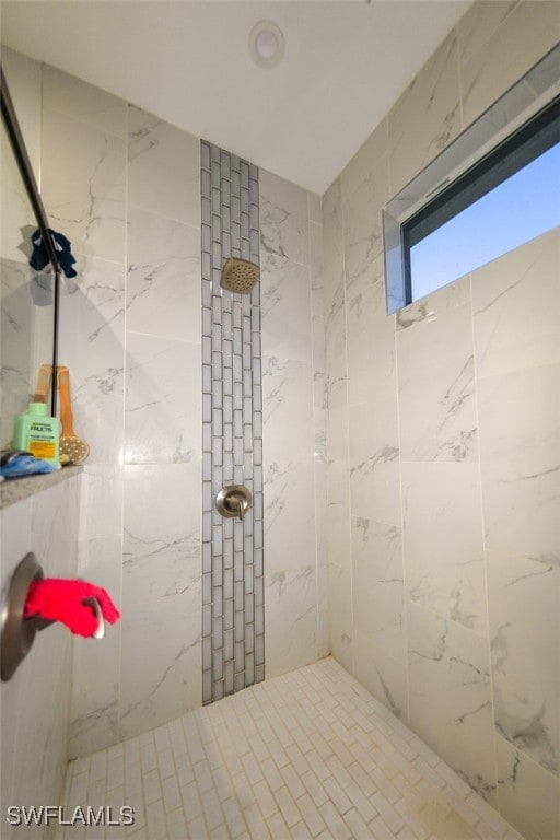 bathroom with a tile shower