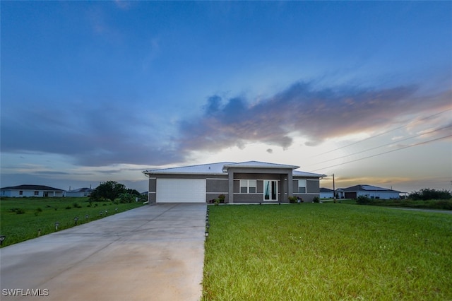 view of front facade featuring a lawn and a garage