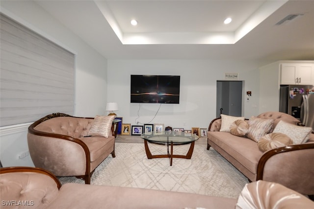 living room with a tray ceiling