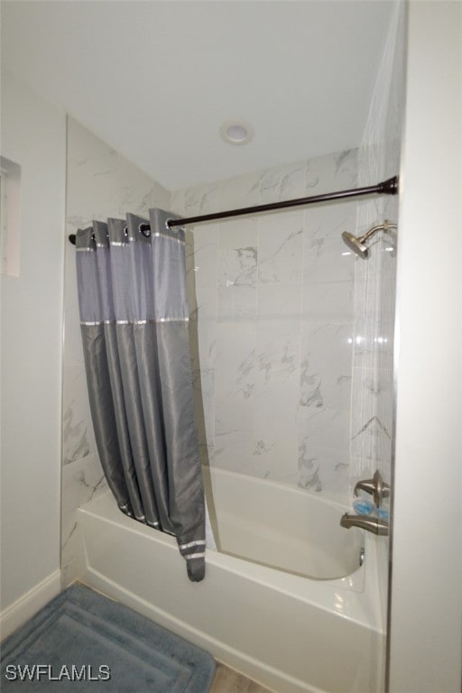 bathroom with shower / bath combo with shower curtain