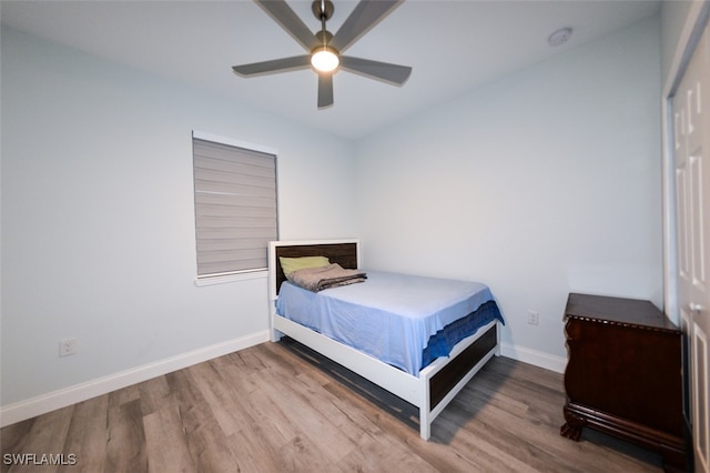 bedroom featuring wood-type flooring, a closet, and ceiling fan