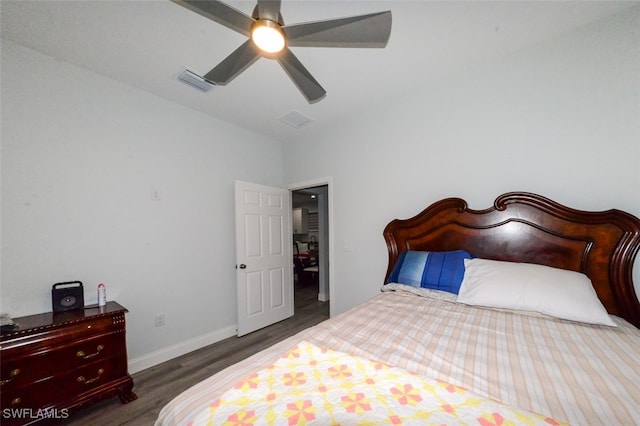 bedroom with ceiling fan and dark wood-type flooring