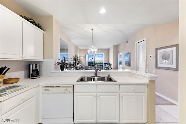 kitchen with white cabinetry, kitchen peninsula, dishwasher, light tile patterned floors, and sink