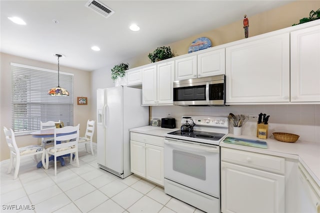 kitchen with white cabinetry, tasteful backsplash, white appliances, light tile patterned floors, and decorative light fixtures