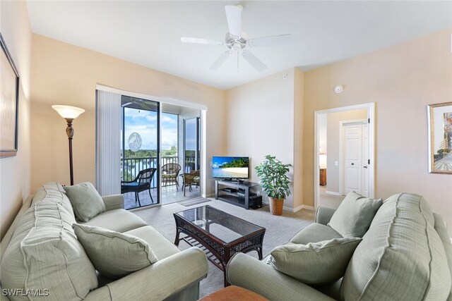 carpeted living room with ceiling fan