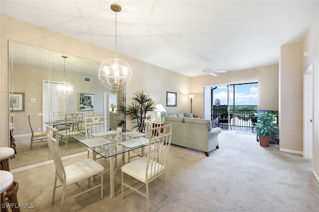 carpeted dining room featuring ceiling fan with notable chandelier