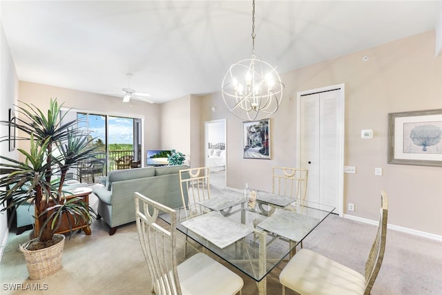 carpeted dining room with ceiling fan with notable chandelier