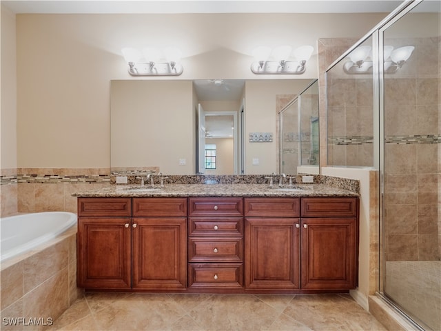 bathroom with tile patterned floors, independent shower and bath, and vanity