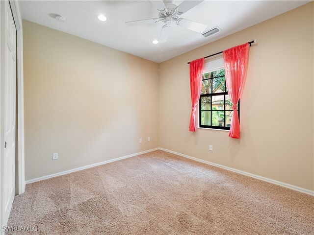 unfurnished room with carpet flooring and ceiling fan