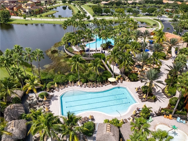 view of swimming pool featuring a patio area and a water view