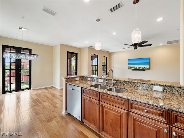 kitchen featuring light wood-type flooring, dishwasher, sink, light stone countertops, and ceiling fan