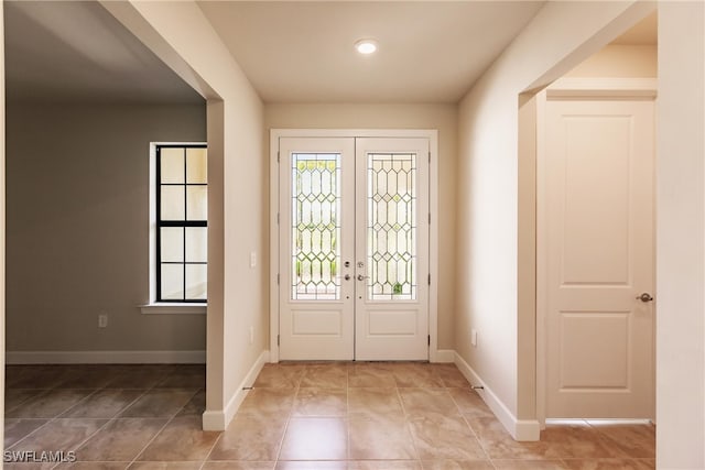 tiled entryway featuring french doors