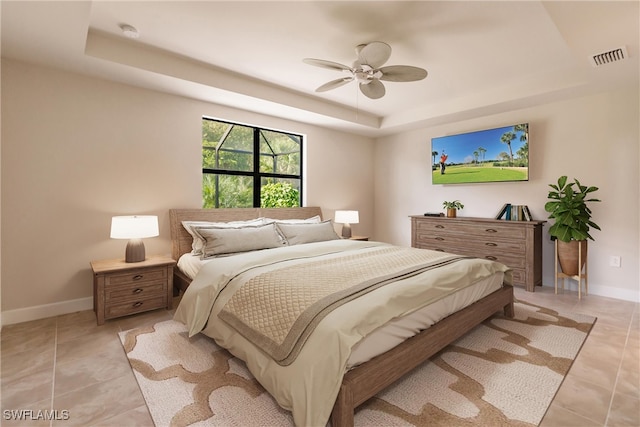 tiled bedroom with ceiling fan and a raised ceiling