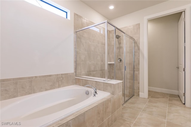 bathroom featuring tile patterned flooring and separate shower and tub