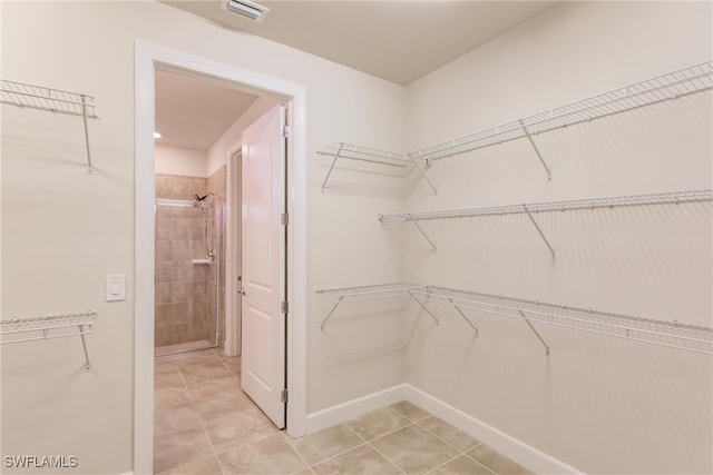 spacious closet featuring light tile patterned flooring