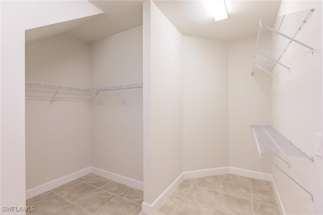 spacious closet featuring light tile patterned flooring