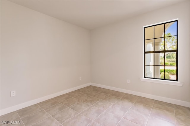 spare room with a healthy amount of sunlight and light tile patterned floors