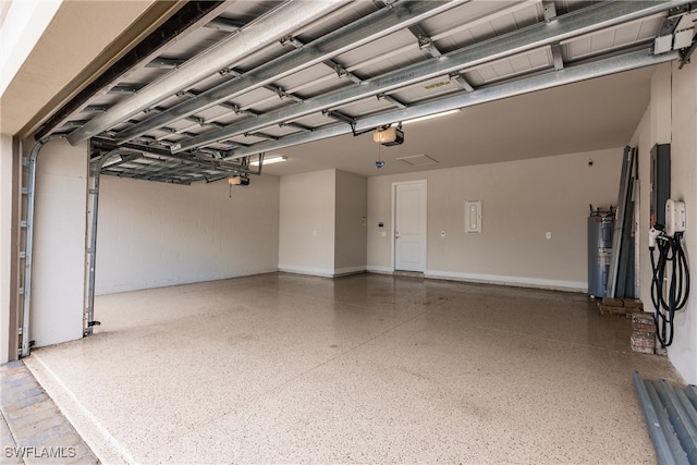 garage with a garage door opener and electric water heater