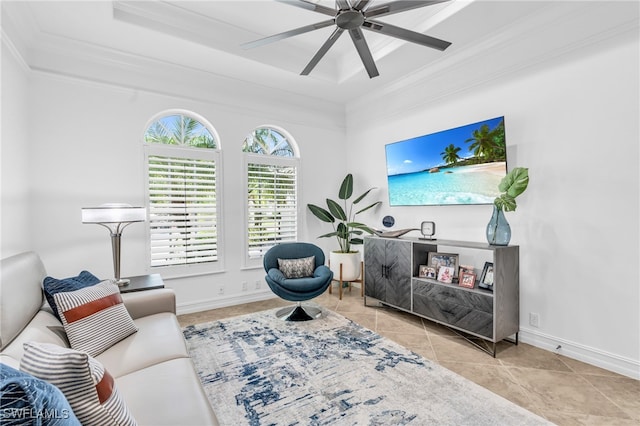 living room with a tray ceiling, ceiling fan, crown molding, and light tile patterned flooring