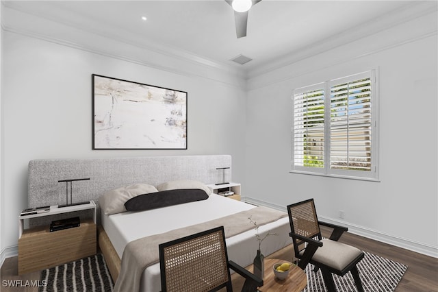 bedroom with dark hardwood / wood-style flooring, ceiling fan, and ornamental molding