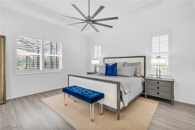 bedroom with ceiling fan and light hardwood / wood-style floors