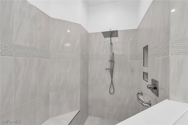 bathroom with a tile shower