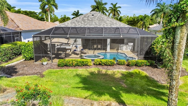 view of swimming pool with a lawn, glass enclosure, a patio area, and an in ground hot tub