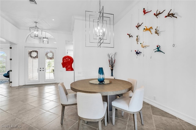 tiled dining area featuring ornamental molding and french doors