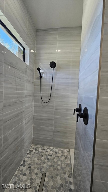 bathroom with tiled shower