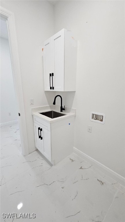 washroom with washer hookup, cabinets, and sink