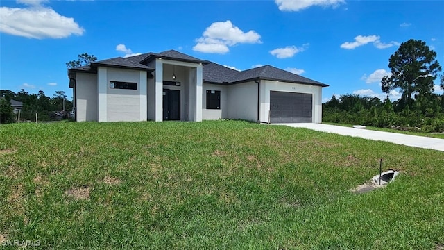 view of front of house featuring a front yard and a garage