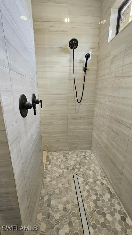 bathroom with a tile shower