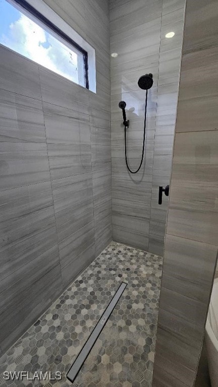 bathroom with a shower with door